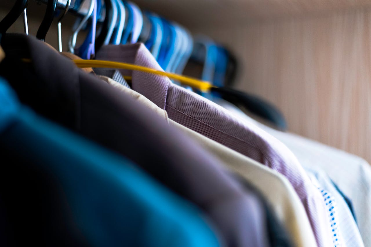 Crafting Captivating Headlines: Your awesome post title goes here Close-up of various shirts hanging on colorful hangers inside a wardrobe.